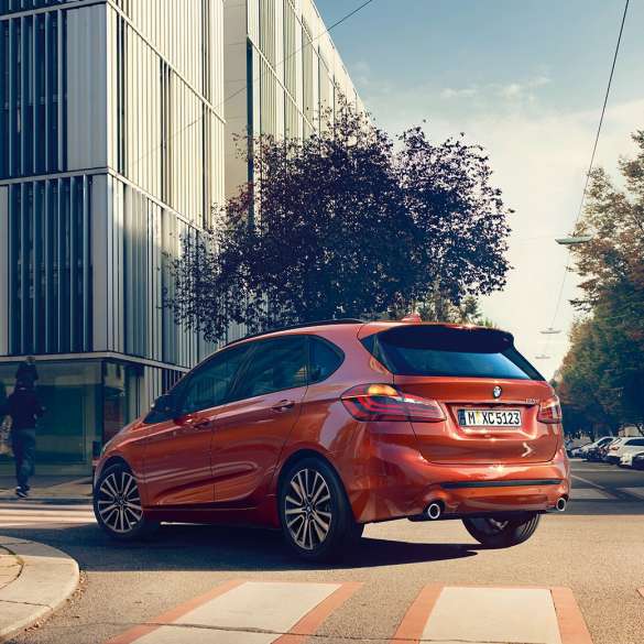 Driving dynamics BMW 2 Series Active Tourer Driving dynamics BMW 2 Series Active Tourer 220i 2018 F45 Sunset Orange metallic three-quarter rear view