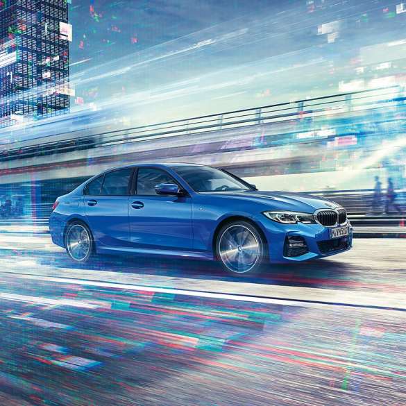 BMW 3 Series Sedan, driving side view. Driving shot of the BMW 3 Series Sedan from the side on the day in an urban setting.