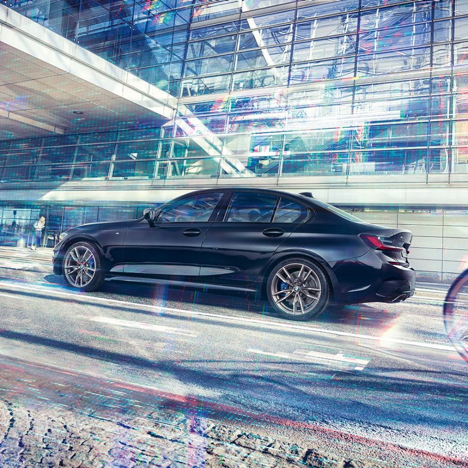 BMW 3 Series Sedan, BMW M340i xDrive. Side view of the BMW M340i xDrive in front of an urban building.