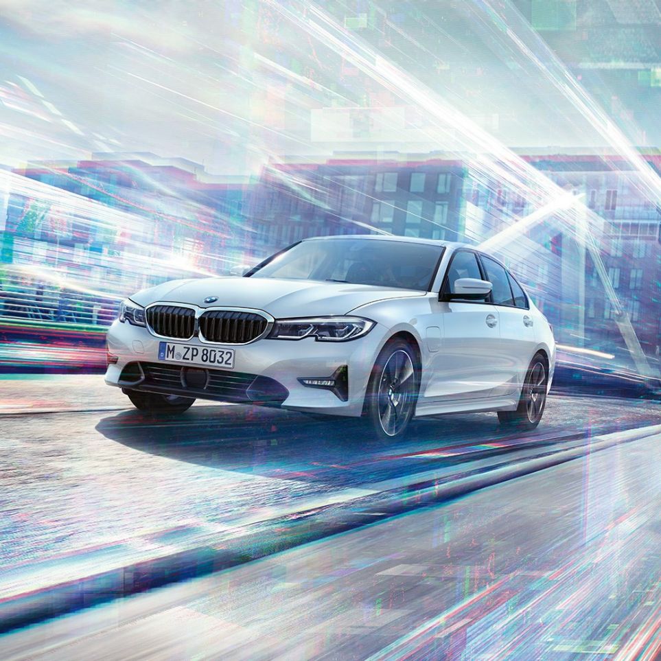 BMW 3 Series Sedan, driving 330e. BMW 3 Series Sedan 330e driving against an urban backround.