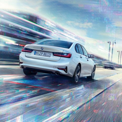 BMW 3 Series Sedan, 330e rear view. Three-quarter rear view of the driving BMW 3 Series Sedan 330e.