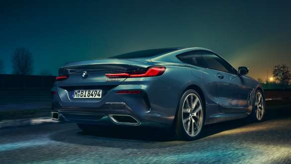Exhaust tailpipes and rear wheels. BMW 8 Series Coupé, low rear view, exhaust tailpipes and rear wheels.
