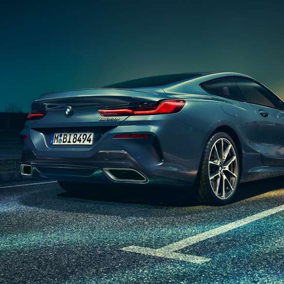 BMW 8 Series Coupé, three-quarter rear view. BMW 8 Series Coupé, three-quarter rear view, standing in front of night scenery.