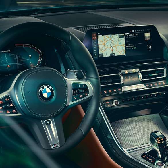 BMW 8 Series Coupé, cockpit. BMW 8 Series Coupé, cockpit, close-up view with steering wheel and control display.