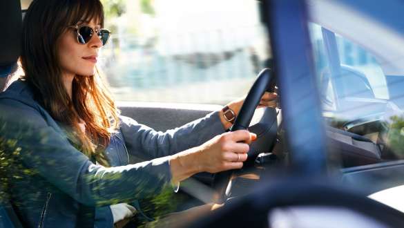 Woman with sun glasses driving a BMW i3 Woman with sun glasses driving a BMW i3