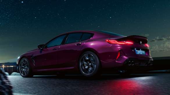 BMW M8 Competition Gran Coupé three-quarter side view low angle shot BMW M8 Competition Gran Coupé with M xDrive F93 2020 BMW Individual Ametrine metallic three-quarter side view low angle shot