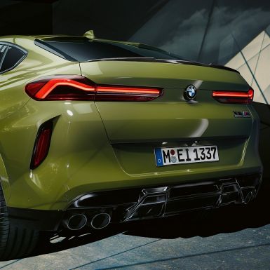 BMW X6 M Competition three-quarter rear view BMW X6 M Competition with M Sport exhaust system F96 BMW Individual Special Paint Urban Green three-quarter rear view