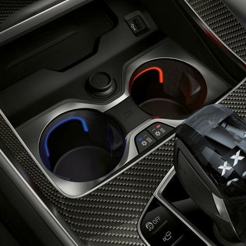 Temperature-controlled cupholder. Close-up of the BMW interior with focus on temperature-controlled cupholder.