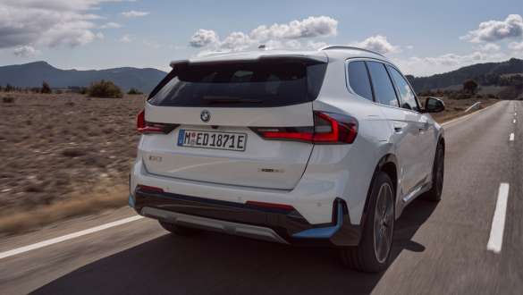 BMW X1 U11 BEV 3/4 rear view driving
