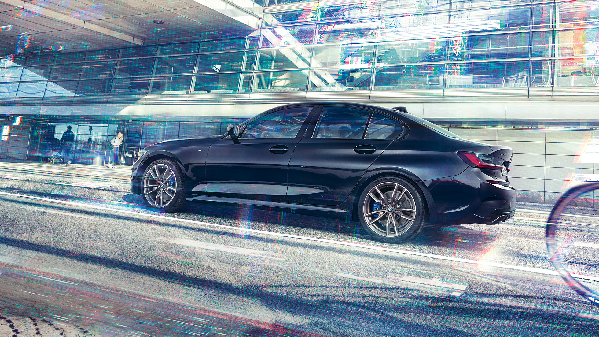 BMW 3 Series Sedan, BMW M340i xDrive. Side view of the BMW M340i xDrive in front of an urban building.