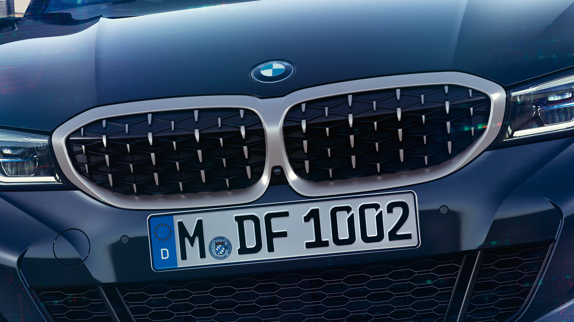 BMW 3 Series Sedan, BMW double kidney grille. Frontal close-up of the BMW double kidney grille with mesh design of the BMW 3 Series Sedan M340i xDrive.