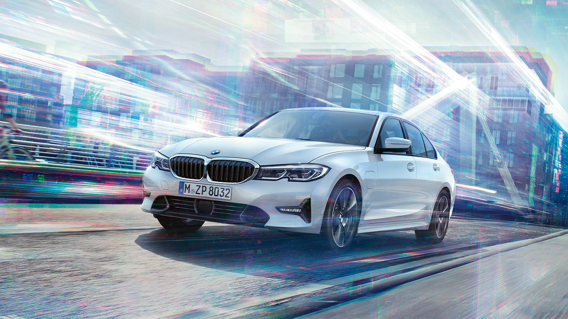 BMW 3 Series Sedan, driving 330e. BMW 3 Series Sedan 330e driving against an urban backround.