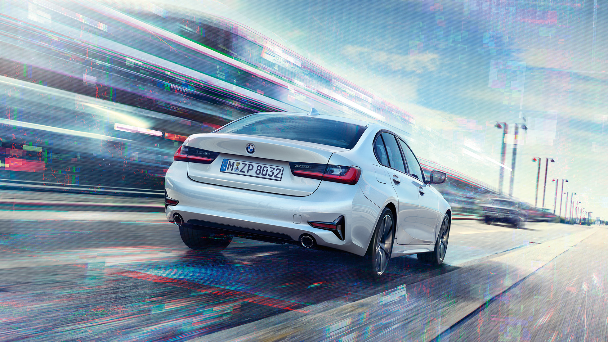 BMW 3 Series Sedan, 330e rear view. Three-quarter rear view of the driving BMW 3 Series Sedan 330e.