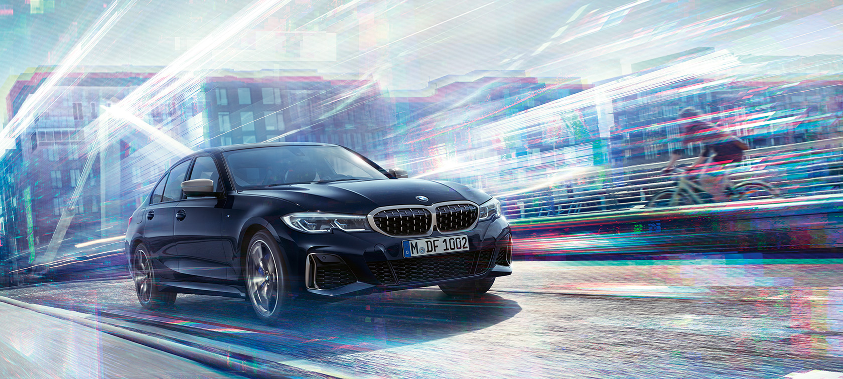 BMW 3 Series Sedan, BMW M340i xDrive. Three-quarter side view of the BMW M340i xDrive driving on the road against an urban backround.