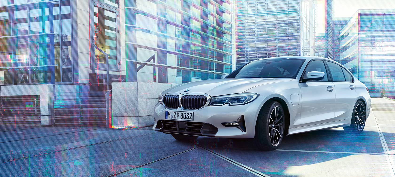 BMW 3 Series Sedan 330e. Three-quarter front shot of the BMW 3 Series Sedan 330e against an urban backround.