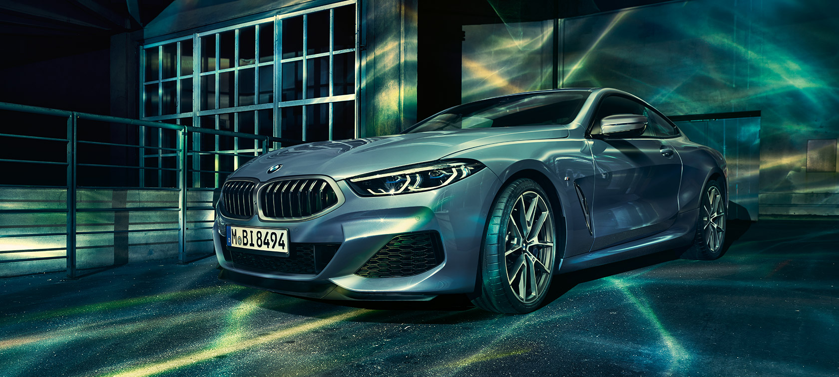 The BMW 8 Series Coupé, three-quarter front shot. The BMW 8 Series Coupé, three-quarter front shot, in front of industry building.