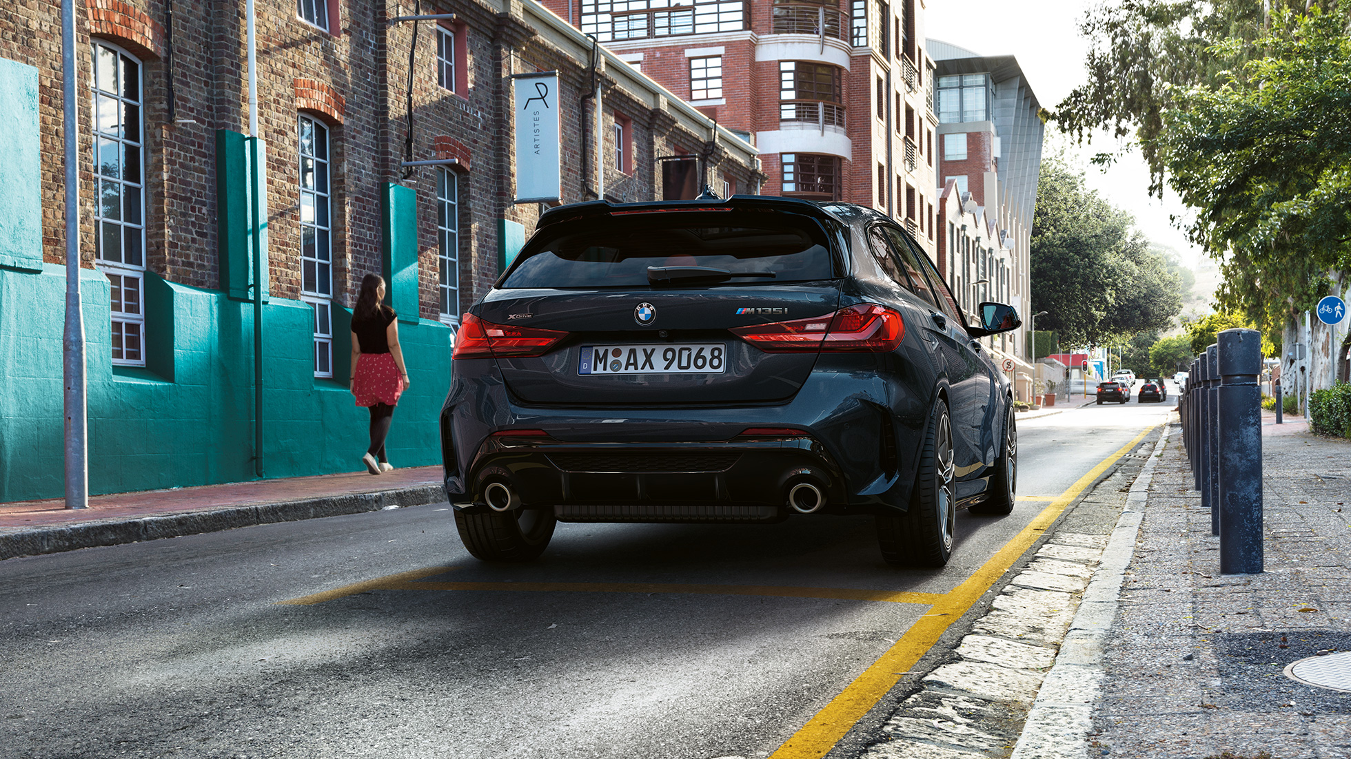 BMW M135i xDrive, rear view. BMW M135i xDrive in Black Sapphire metallic, rear view parking.
