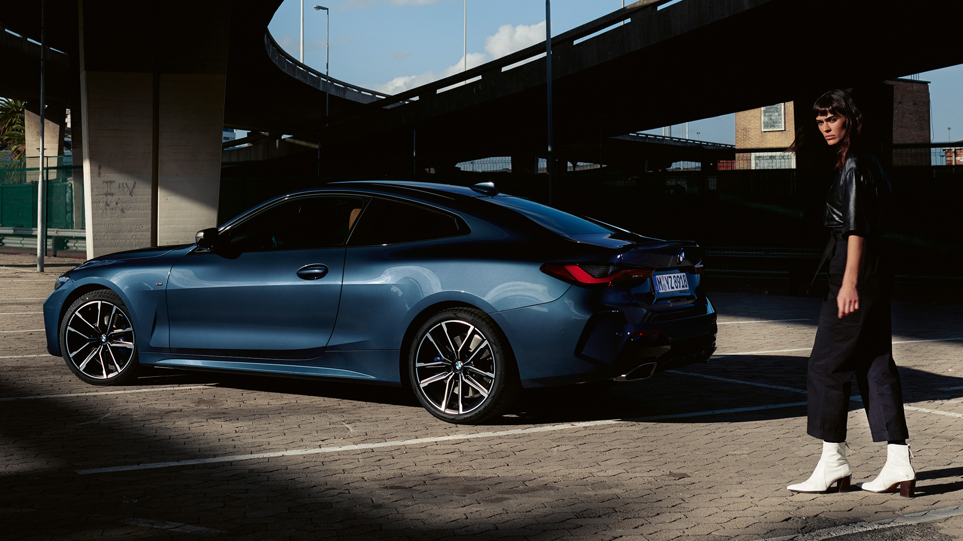Three quarter rear view model BMW M440i xDrive Coupé G22 2020 BMW M440i xDrive Coupé Arctic Race Blue metallic G22 2020 three quarter rear view with model