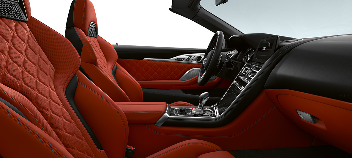 Full fine-grain leather 'Merino' | Sakhir Orange and BMW Individual interior trim Piano Finish Black. BMW M8 Competition Convertible, interior in full fine-grain leather 'Merino' | Sakhir Orange and BMW Individual interior trim Piano Finish Black.