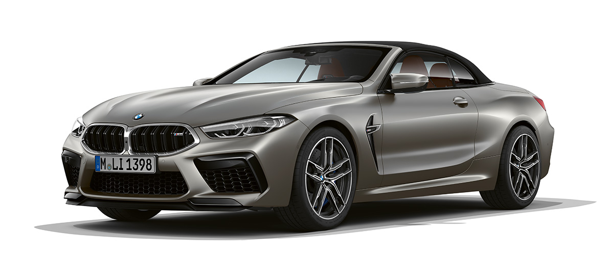 BMW M8 Convertible, three-quarter side view front. BMW M8 Convertible in Frozen Dark Silver, three-quarter side view with front.