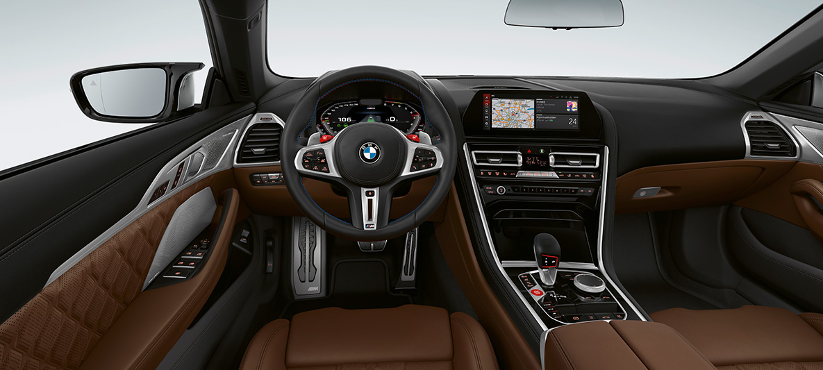BMW M8 Convertible, cockpit. BMW M8 Convertible, cockpit with M leather steering wheel with M1/M2 buttons in red.