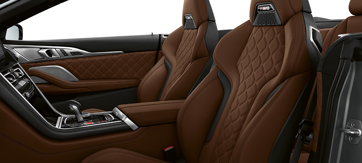M Sport seats with M badge. BMW M8 Convertible, interior with M Sport seats in full fine-grain leather 'Merino' Taruma Brown.