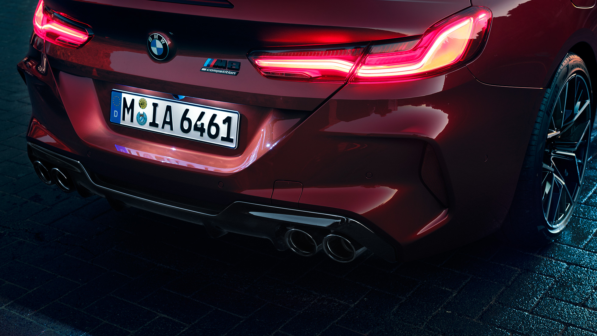 BMW M8 Competition Convertible, close-up rear. BMW M8 Competition Convertible in Motegi Red metallic, close-up rear with LED rear lights and M8 Competiton badge.