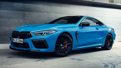 BMW M8 Gran Coupé (F93) three-quarter side view standing with model BMW M8 Gran Coupé (F93) three-quarter side view standing with model
