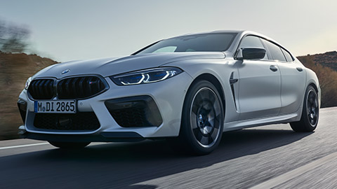 BMW M8 Gran Coupé (F93) three-quarter side view standing with model BMW M8 Gran Coupé (F93) three-quarter side view standing with model