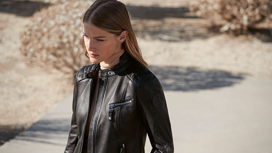 A female model is wearing the BMW Leather Jacket for ladies.