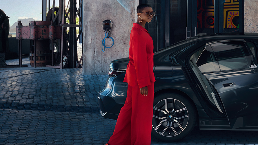 BMW Destination Charging woman in front of a BMW building in the backround